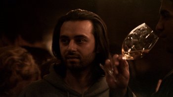 Movie still from “Man Push Cart” (2005), directed by Ramin Bahrani – A man with long hair holding a wine glass; Close Up shot, Over the shoulder angle