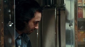 Movie still from “Man Push Cart” (2005), directed by Ramin Bahrani – A person with long black hair; Close Up shot, Over the shoulder angle