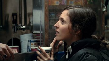 Movie still from “Man Push Cart” (2005), directed by Ramin Bahrani – A woman sitting in front of a window holding a cup of coffee; Close Up shot, Over the shoulder angle