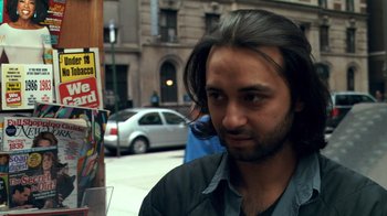 Movie still from “Man Push Cart” (2005), directed by Ramin Bahrani – A person with long black hair; Close Up shot, Over the shoulder angle
