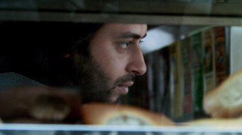 Movie still from “Man Push Cart” (2005), directed by Ramin Bahrani – A man with a beard looking out of a refrigerator; Close Up shot, Low angle