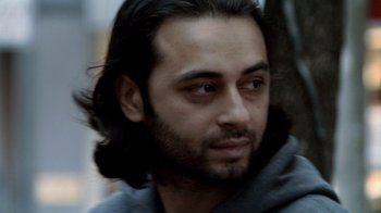 Movie still from “Man Push Cart” (2005), directed by Ramin Bahrani – A person with long black hair; Close Up shot, Low angle