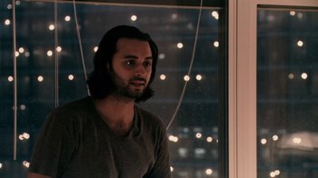 Movie still from “Man Push Cart” (2005), directed by Ramin Bahrani – A man standing in front of a window at night; Close Up shot, Over the shoulder angle