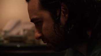 Movie still from “Man Push Cart” (2005), directed by Ramin Bahrani – A man's face with long dark hair; Close Up shot, Over the shoulder angle