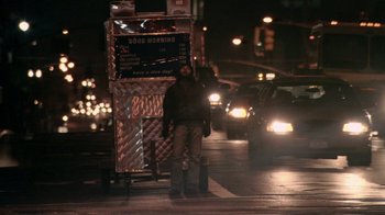 Movie still from “Man Push Cart” (2005), directed by Ramin Bahrani – A man standing on the side of the road at night; Wide shot, Low angle