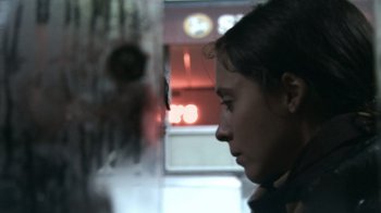 Movie still from “Man Push Cart” (2005), directed by Ramin Bahrani – A woman looking out of a window at night; Close Up shot, Over the shoulder angle