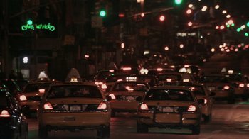 Movie still from “Man Push Cart” (2005), directed by Ramin Bahrani – Many cars that are in the street at night; Extreme Wide shot, Over the shoulder angle