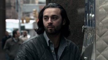 Movie still from “Man Push Cart” (2005), directed by Ramin Bahrani – A person with long black hair; Close Up shot, Over the shoulder angle