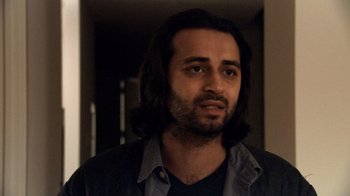 Movie still from “Man Push Cart” (2005), directed by Ramin Bahrani – A person with long black hair; Close Up shot, Over the shoulder angle