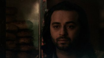 Movie still from “Man Push Cart” (2005), directed by Ramin Bahrani – A person with long black hair; Close Up shot, Low angle
