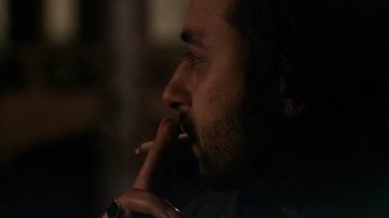 Movie still from “Man Push Cart” (2005), directed by Ramin Bahrani – A person smoking a cigarette; Close Up shot, Over the shoulder angle