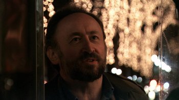 Movie still from “Man Push Cart” (2005), directed by Ramin Bahrani – A person wearing a jacket; Close Up shot, Over the shoulder angle