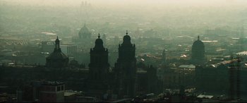Movie still from “Man on Fire” (2004), directed by Tony Scott – A view of a city from a distance with two domed buildings; Extreme Wide shot, High angle