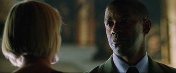 Movie still from “Man on Fire” (2004), directed by Tony Scott – A person talking to another person; Close Up shot, Over the shoulder angle