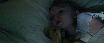 Movie still from “Man on Fire” (2004), directed by Tony Scott – A little girl laying in bed with a teddy bear; Close Up shot, Overhead angle