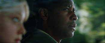 Movie still from “Man on Fire” (2004), directed by Tony Scott – A man's face in a dark room; Close Up shot, Low angle