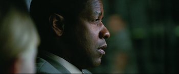 Movie still from “Man on Fire” (2004), directed by Tony Scott – A man's face looking into the distance; Close Up shot, Low angle