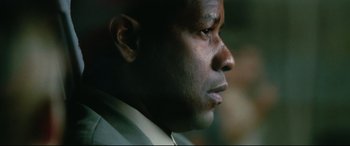 Movie still from “Man on Fire” (2004), directed by Tony Scott – A man's face in a dark room; Extreme Close Up shot, Low angle