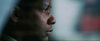 Movie still from “Man on Fire” (2004), directed by Tony Scott – A man's face with his eyes wide open; Close Up shot, Low angle
