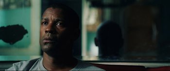 Movie still from “Man on Fire” (2004), directed by Tony Scott – A person looking at the camera; Close Up shot, Over the shoulder angle