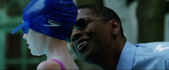 Movie still from “Man on Fire” (2004), directed by Tony Scott – A person wearing sunglasses; Close Up shot, Over the shoulder angle