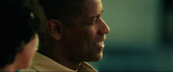 Movie still from “Man on Fire” (2004), directed by Tony Scott – A man's smiling face; Close Up shot, Over the shoulder angle