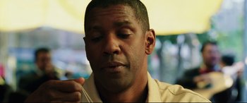 Movie still from “Man on Fire” (2004), directed by Tony Scott – A person holding something in his hand; Close Up shot, Low angle