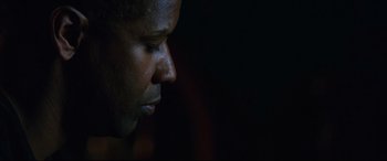 Movie still from “Man on Fire” (2004), directed by Tony Scott – A man's face in the dark; Close Up shot, Low angle