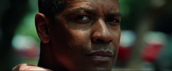 Movie still from “Man on Fire” (2004), directed by Tony Scott – A man's face with a lot of dirt on his face; Close Up shot, Low angle
