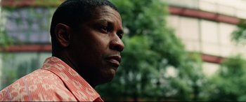 Movie still from “Man on Fire” (2004), directed by Tony Scott – A person wearing a red shirt; Close Up shot, Low angle