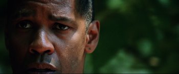 Movie still from “Man on Fire” (2004), directed by Tony Scott – A man's face with ear piercings; Close Up shot, Low angle