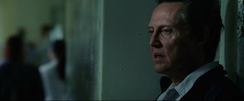 Movie still from “Man on Fire” (2004), directed by Tony Scott – A person looking at a wall; Close Up shot, Over the shoulder angle