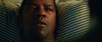 Movie still from “Man on Fire” (2004), directed by Tony Scott – A person laying in a bed; Close Up shot, Overhead angle