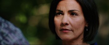 Movie still from “Man on Fire” (2004), directed by Tony Scott – A woman's face with trees in the background; Close Up shot, Low angle