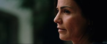 Movie still from “Man on Fire” (2004), directed by Tony Scott – A woman's face with a black background; Close Up shot, Low angle
