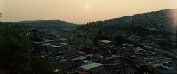 Movie still from “Man on Fire” (2004), directed by Tony Scott – The sun is setting over a city with many buildings; Extreme Wide shot, High angle