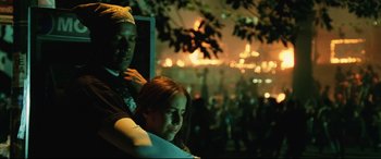 Movie still from “Man on Fire” (2004), directed by Tony Scott – A man and a woman sitting in front of a tree; Close Up shot, Low angle
