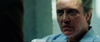 Movie still from “Man on Fire” (2004), directed by Tony Scott – A man's face in a blue shirt; Close Up shot, Over the shoulder angle