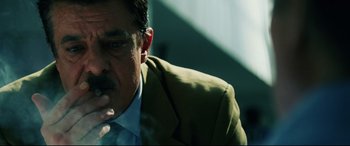 Movie still from “Man on Fire” (2004), directed by Tony Scott – A person smoking a cigarette; Close Up shot, Low angle