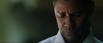 Movie still from “Man on Fire” (2004), directed by Tony Scott – A person wearing a white dress shirt; Close Up shot, Low angle