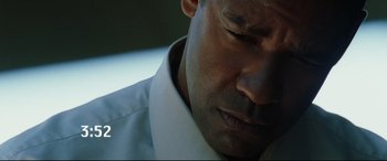 Movie still from “Man on Fire” (2004), directed by Tony Scott – A man's face in a white shirt; Close Up shot, Low angle