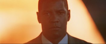 Movie still from “Man on Fire” (2004), directed by Tony Scott – A person wearing a suit and tie; Close Up shot, Low angle