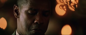 Movie still from “Man on Fire” (2004), directed by Tony Scott – A man's face in the dark; Close Up shot, Low angle