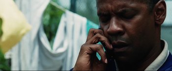 Movie still from “Man on Fire” (2004), directed by Tony Scott – A person talking on a cell phone; Close Up shot, Low angle