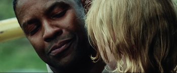 Movie still from “Man on Fire” (2004), directed by Tony Scott – A man and a child's face; Extreme Close Up shot, Over the shoulder angle