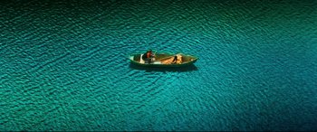 Two people in a small boat on a body of water