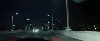 Movie still from “Maniac” (2012), directed by Franck Khalfoun – A car driving down a street at night; Extreme Wide shot, High angle