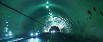 Movie still from “Maniac” (2012), directed by Franck Khalfoun – Cars driving down a road through a tunnel; Extreme Wide shot, High angle