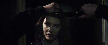 Movie still from “Maniac” (2012), directed by Franck Khalfoun – A woman holding a knife over her head; Close Up shot, Over the shoulder angle
