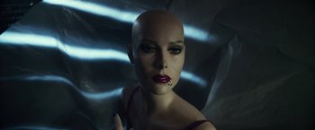 Movie still from “Maniac” (2012), directed by Franck Khalfoun – A woman with a shaved head and lipstick on her lips; Extreme Close Up shot, Low angle